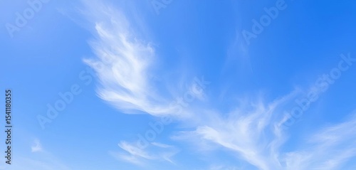 Vast, clear blue sky with wispy cirrus clouds, subtle texture, view, day