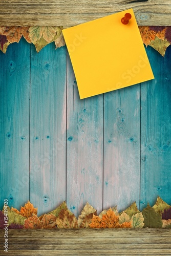 Autumn leaves with yellow note