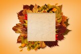 Flat design blank paper is being shown on peach-orange gradient with autumn leaves border