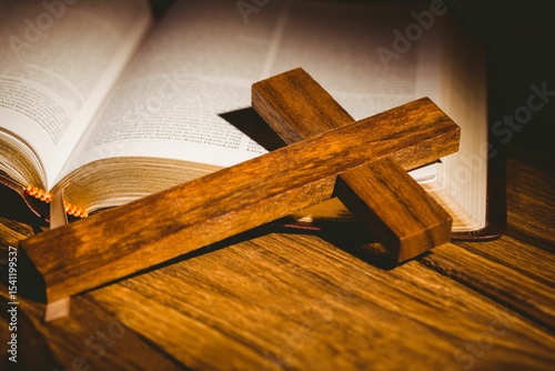 Close-up of cross kept on open bible