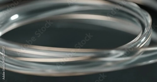 Blue water droplets on glass and metal, creating liquid ripples and light reflections