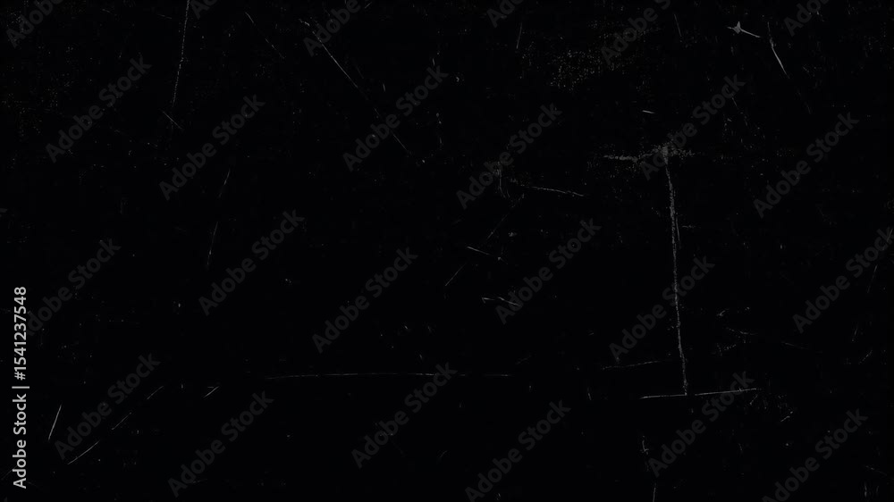 A dark, textured surface is displayed, featuring scratches and subtle variations in tone.