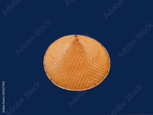 The dark blue background in the picture is a beautiful, intricately woven basket made from bamboo painted in beautiful brown colors. There is a head cover inside that is made into a circle. 