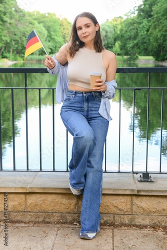 Young woman with flag of Ge...