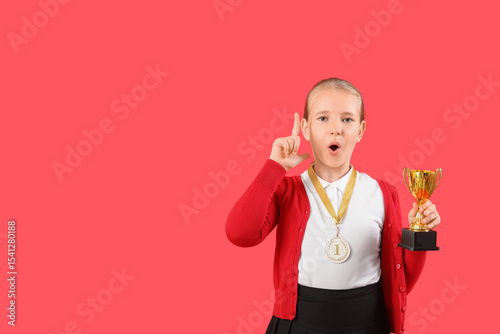 Cute little schoolgirl with...