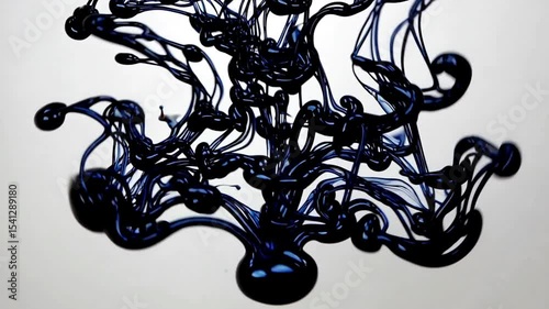 Swirl of black ink mixes clear water in glass. Fluid motion shapes textures. Creativity transformation. Liquid form. Experiment with paint and liquid. White background.
