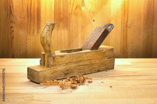 Vintage Wooden Plane Tool on Rustic Wooden Workbench