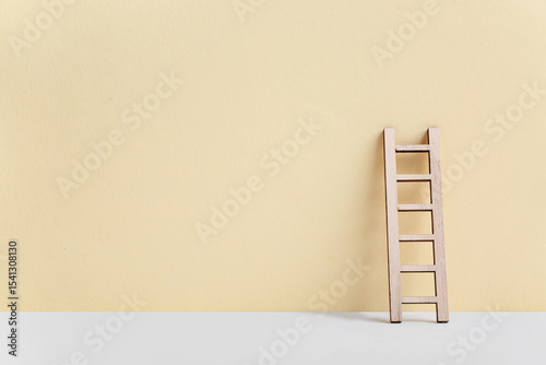 Wooden ladder on beige back...