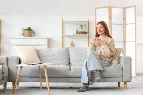 Young woman with cup of tea...