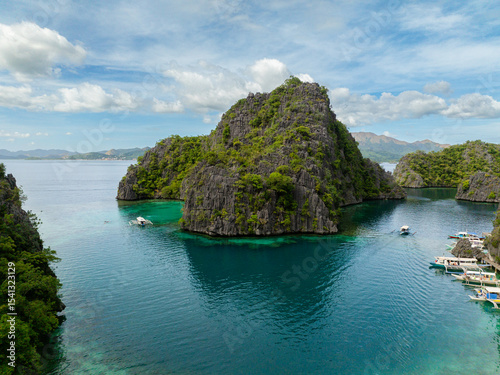 Turquoise water lagoon with group of boats in Kayangan Lake. Coron, Palawan. Philippines.