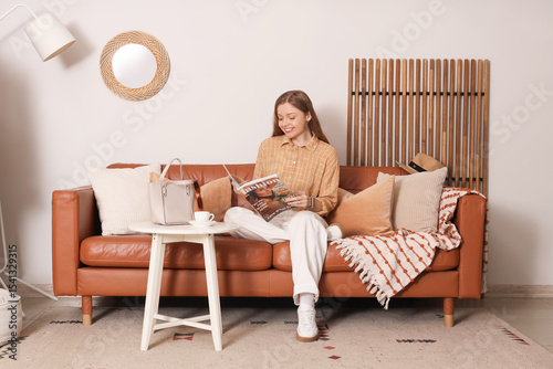 Young woman reading magazin...