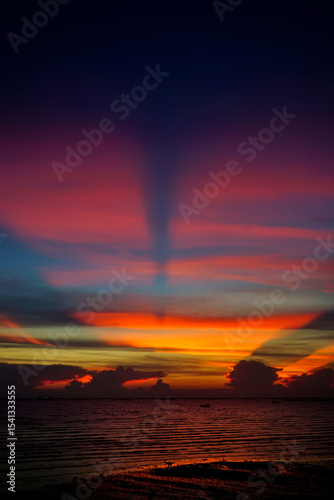 Sunset ray shine through clouds with sea and sky background