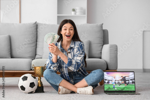 Happy young woman with mone...