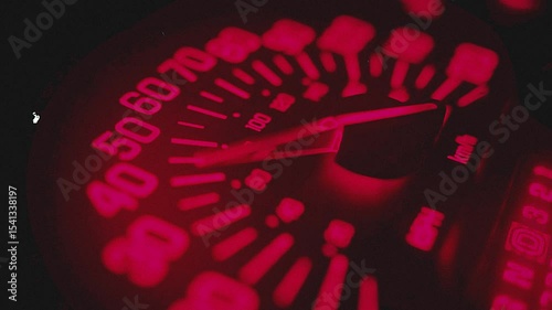 Illuminated Red Speedometer Showing Vehicle Speed with Dark Background