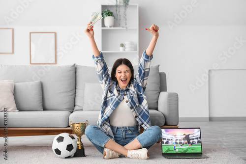 Happy young woman with mone...