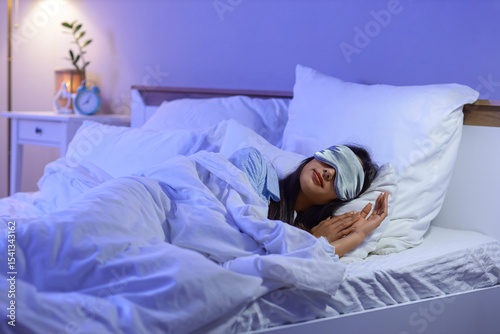 Young woman with mask sleep...