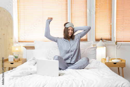 Happy young woman with lapt...