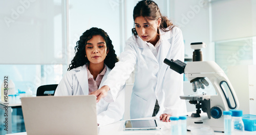 Woman, scientist and team with laptop, review and collaboration for medical research at laboratory. People, computer and feedback for pharmaceutical project with point, innovation and perspective