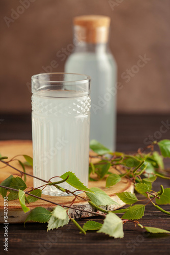 Traditional birch sap. Birch juice in drinking glass. A refreshing traditional Russian spring drink. Copy space