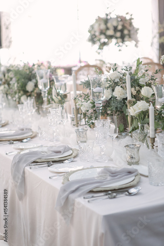 lovely Table setting for magnificent composition from flowers at a wedding , Centerpiece white and orange color palette flower bouquet arrangement