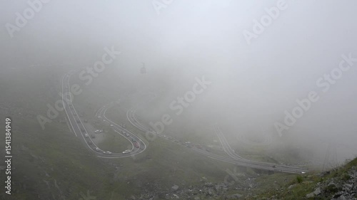 Car Traffic on Transfagarasan, Transalpine Roads in Romania, Mountains View Foggy Day