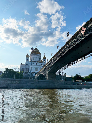 Cathedral of Christ the Saviour and pedestrian bridge over Moscow River on sunny day with blue sky