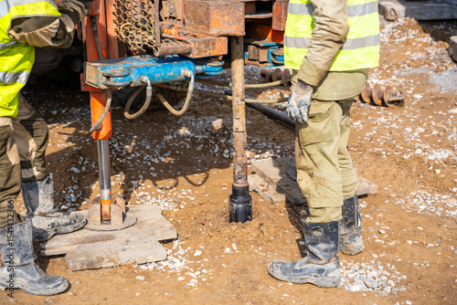 Close-up of soil sampling during pile drilling process. Extraction of subsurface material for geotechnical analysis and foundation assessment