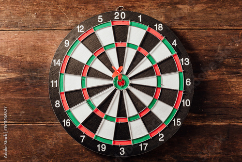 Classic Dartboard on Wooden Background with Red and Green Design