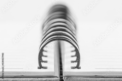 Close-Up of Spiral Binding on Blank Notepad Pages in Monochrome