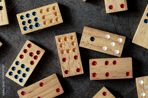 Colorful Wooden Dominoes Arranged on Dark Table Background
