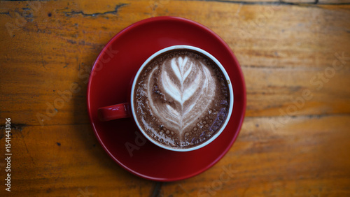 Creamy Latte Art in Red Cup on Minimalist Wooden Table – Coffee Scene in Landscape Orientation