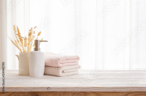 Wooden countertop with space for product montage and set of bathing tools over curtained window background in daylight. NO AI USED