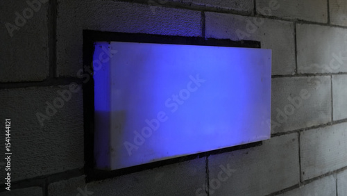 Empty Blue Neon Signboard on Concrete Wall at Night
