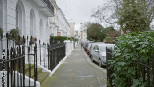 Photography Blurry street view of a quiet chelsea neighborhood in london during winter, showcasing out-of-focus townhouses and parked cars under an overcast sky
