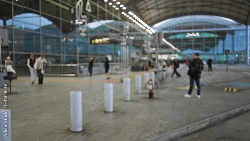 Wallpaper Mural Blurred people walking at terminal 1 airport exterior, showcasing a busy atmosphere with reflective glass walls under an arched roof. Torontodigital.ca