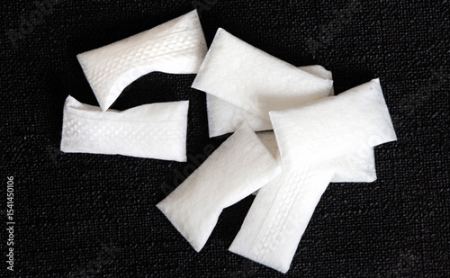 a few white nicotine pouches on a black surface