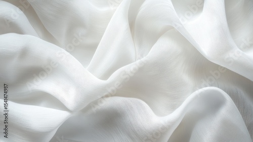 White chiffon fabric elegantly drapes, forming soft, flowing curves. Use as background for design, texture, or product presentation.
