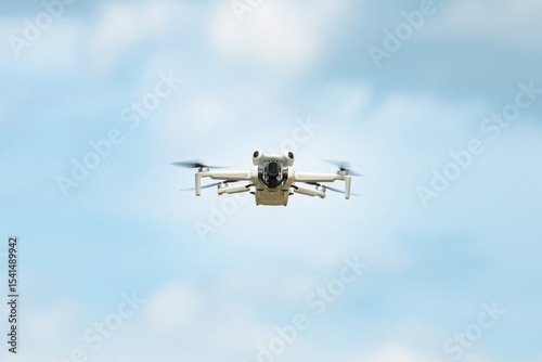 Flying drone in action, aerial copter, digital camera, modern technology used for photography, videography, surveillance and delivery service, agriculture, search and rescue