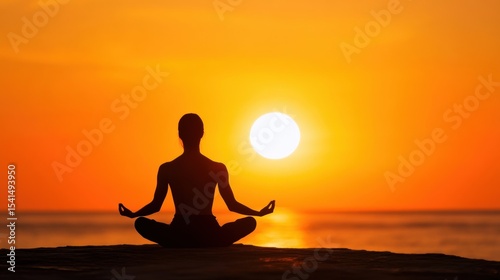 Silhouette of a person meditating in lotus pose against a vibrant sunset