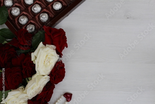 a beautiful bouquet of red and white freshly cut roses and a box of chocolates - a wonderful start to the day