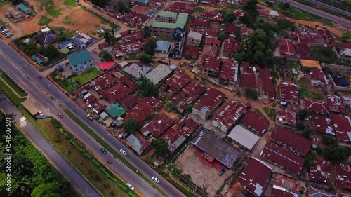 Wallpaper Mural Beautiful aerial of a small suburban neighborhood in Montiya, Nigeria on a sunny day. Traffic drives over a busy road next to the town Torontodigital.ca
