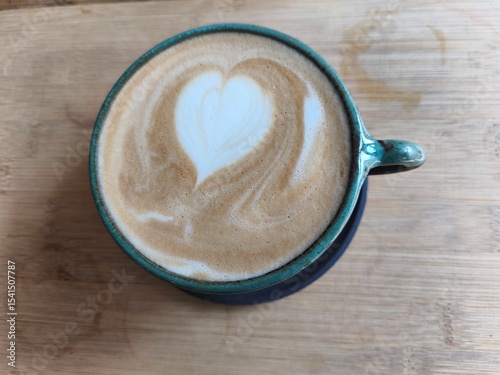 Picture of a cup of coffee with a heart in it.