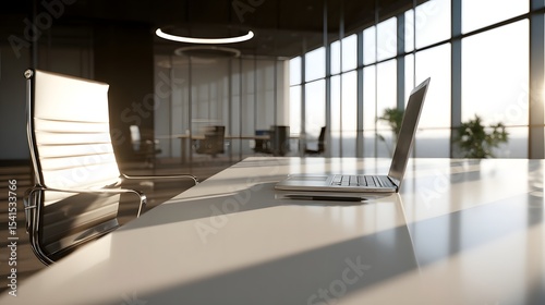 Modern office workspace with a laptop on a sleek desk, illuminated by natural light and shadows