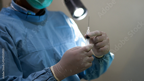 Closeup of Doctor Hand Holding Syringe Ready for Injection