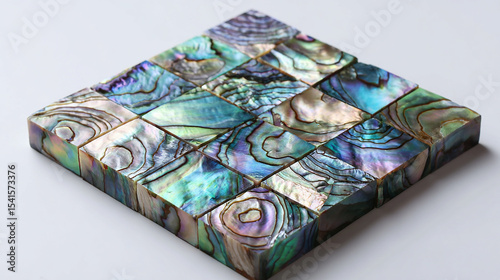 Square abalone shell. The color tone changes from green to purple with an iridescent effect. Each tile has unique colors and textures that resemble natural gemstones.