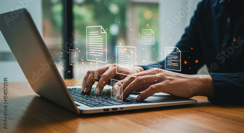 Person typing on a laptop with digital document icons floating above the keyboard and hands visible