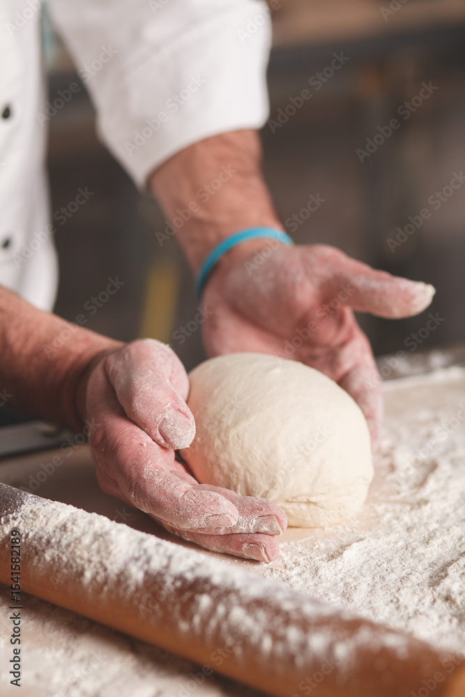Fototapeta premium baker kneading dough
