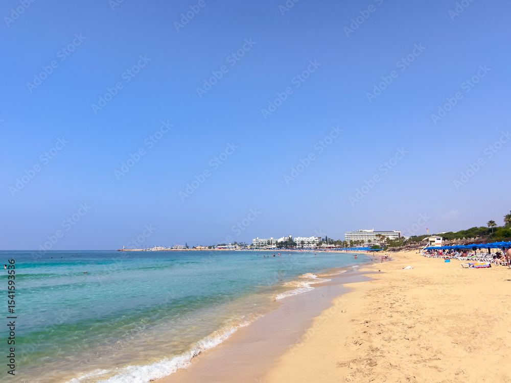 Coastline of Blue Flag beaches in Ayia Napa, Cyprus, with clear turquoise water and golden sand. Concept of paradise vacation, European seaside travel, and Mediterranean summer escape Coastline of Blue Flag beaches in Ayia Napa, Cyprus, with clear turquoise water and golden sand. Concept of paradise vacation, European seaside travel, and Mediterranean summer escape