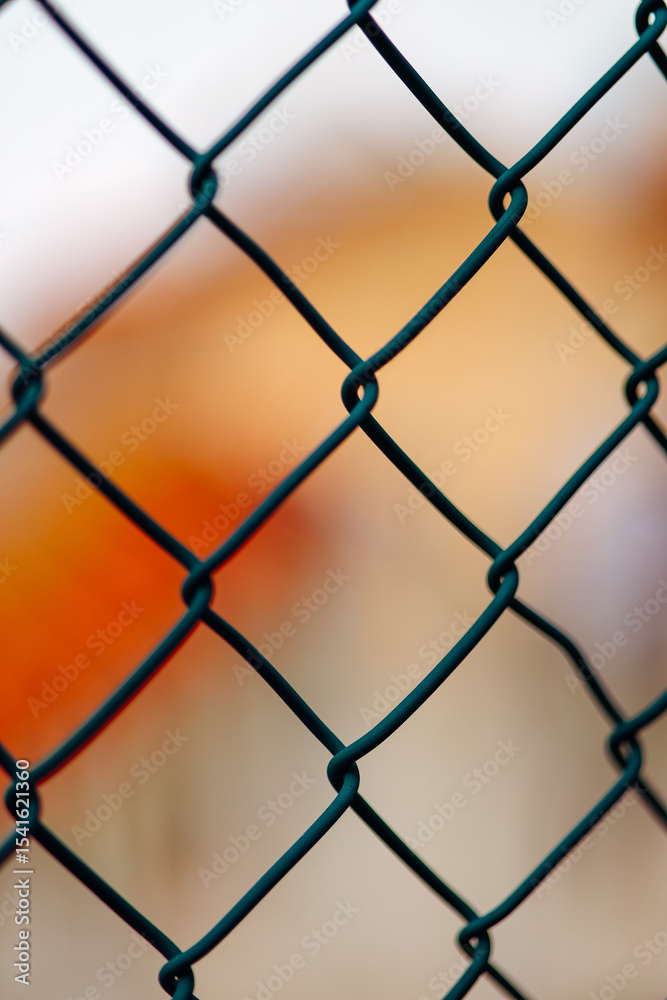 Fototapeta premium Lattice texture on a blurred orange background