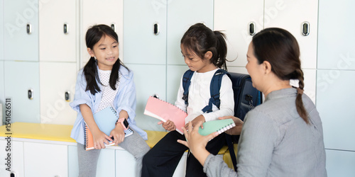 Back to School. Children discussing school supplies and notebooks. photo